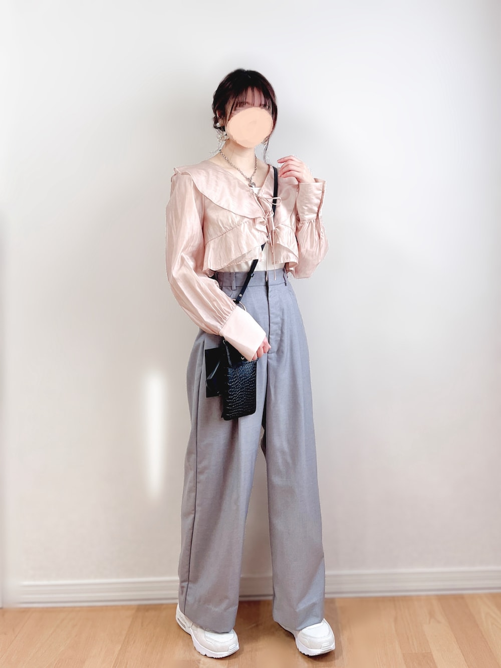 ピンク系のシャツ/ブラウス、グレー系のスラックス、ベージュ系のスニーカーを着用したレディースの春コーディネートの2枚目の写真