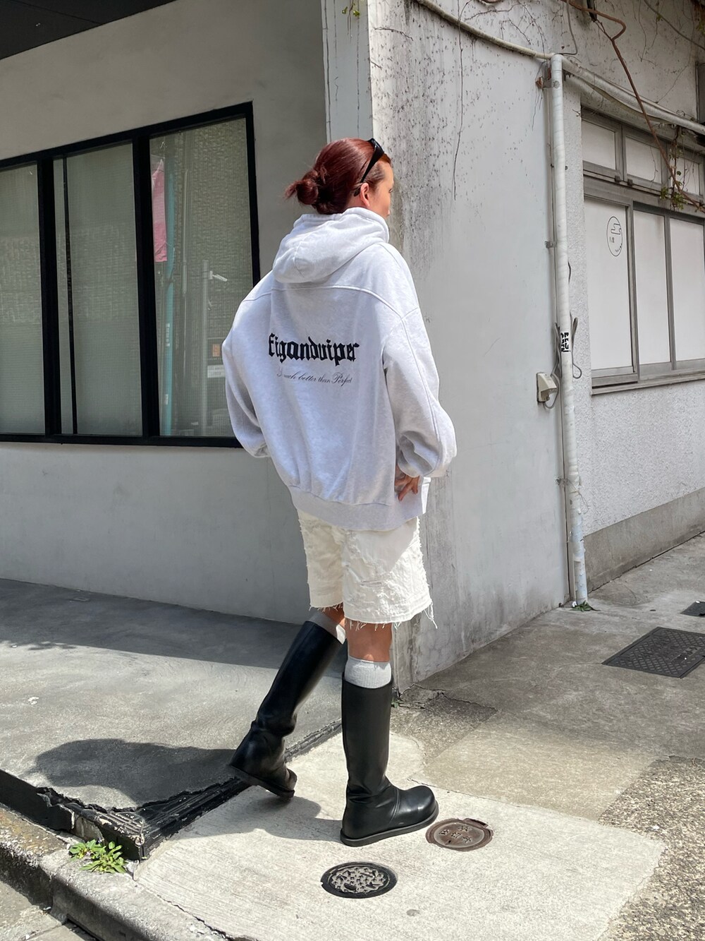 ホワイト系のパーカー、ホワイト系のデニムパンツ、ブラック系のブーツを着用したレディースの春コーディネートの2枚目の写真