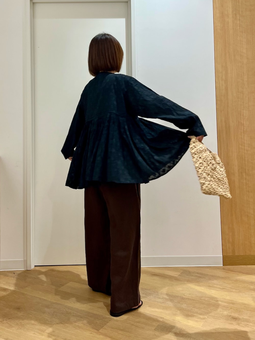 ブラック系のシャツ/ブラウス、ベージュ系のハンドバッグ、ブラウン系のその他パンツを着用したレディースの夏コーディネートの5枚目の写真