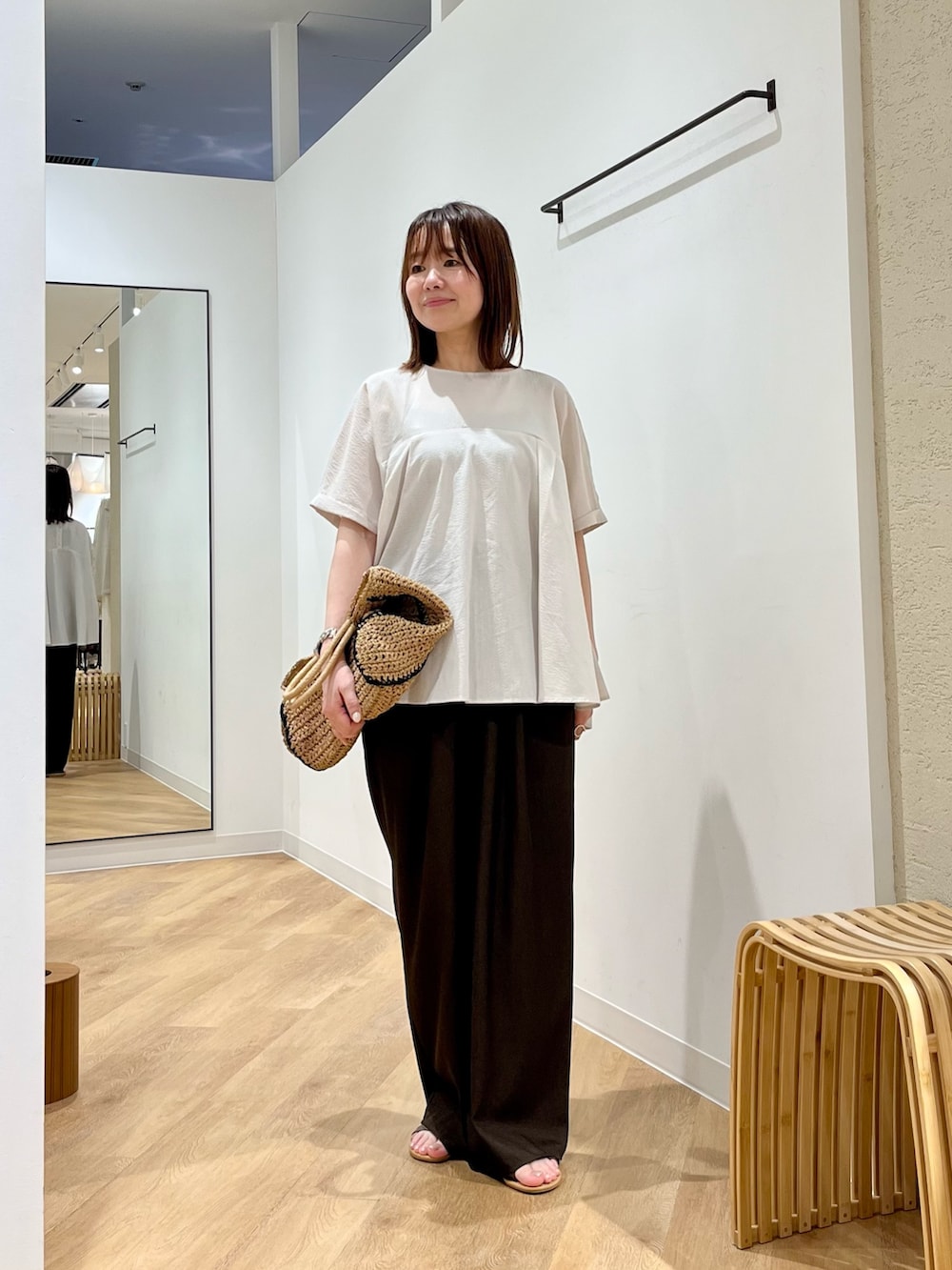 ベージュ系のトートバッグ、グレー系のシャツ/ブラウス、ブラウン系のサンダルを着用したレディースの夏コーディネートの2枚目の写真