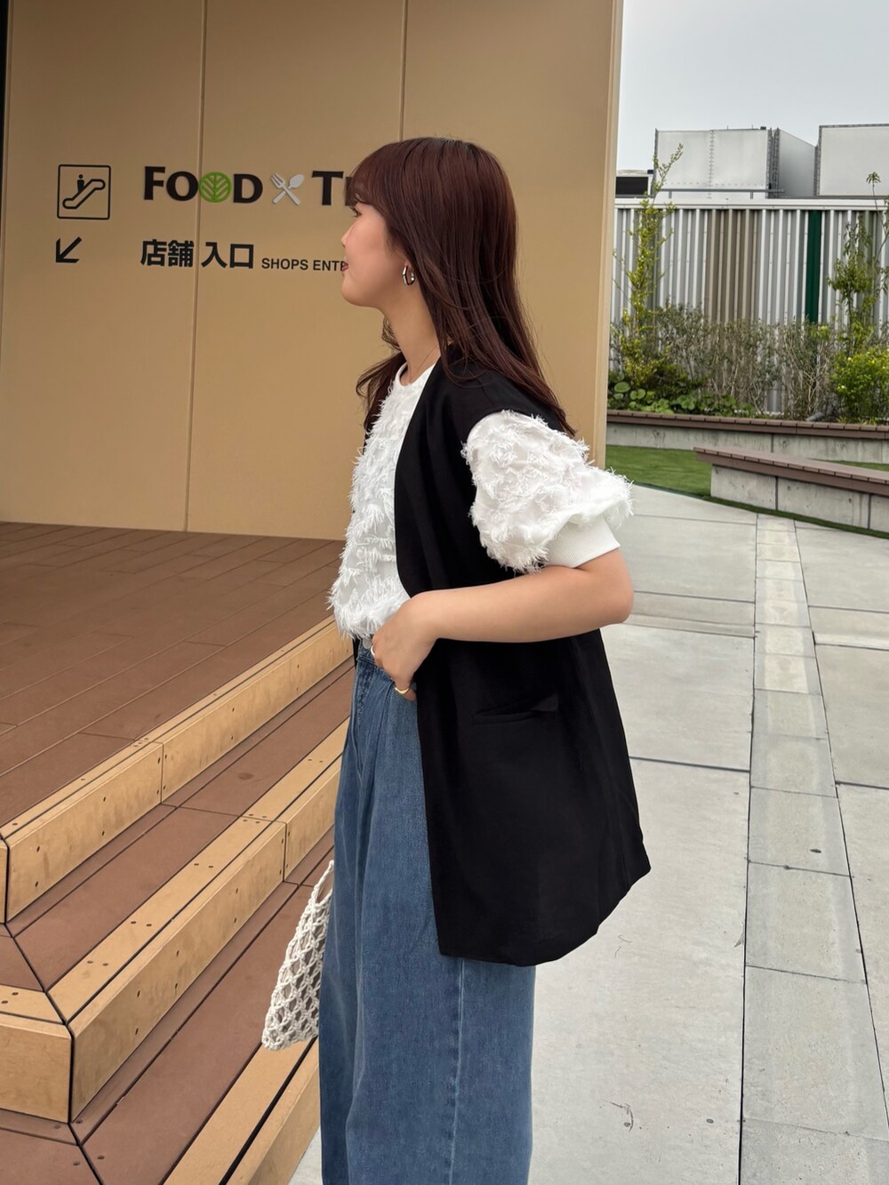 ブラック系のその他アウター、ホワイト系のシャツ/ブラウス、ブルー系のデニムパンツを着用したレディースの春コーディネートの4枚目の写真