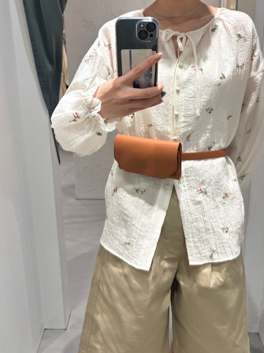 ホワイト系のシャツ/ブラウス、ベージュ系のその他パンツ、イエロー系のボディバッグ/ウエストポーチを着用したレディースの春コーディネートの2枚目の写真
