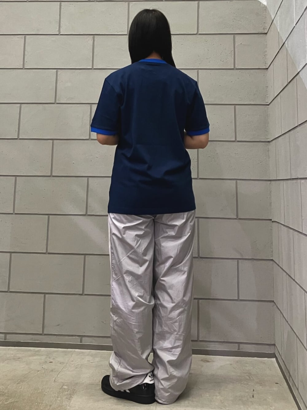 グレー系のその他パンツ、ブルー系のTシャツ/カットソー、ブラック系のスニーカーを着用したレディースの春コーディネートの3枚目の写真