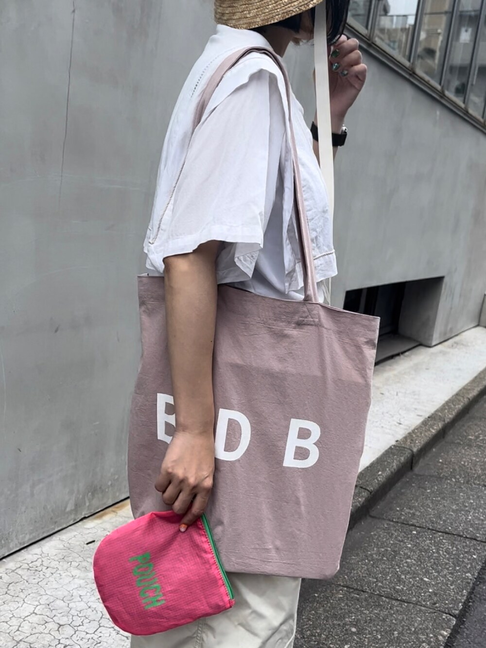 ピンク系のトートバッグ、ホワイト系のその他パンツ、ホワイト系のTシャツ/カットソーを着用したレディースの夏コーディネートの2枚目の写真