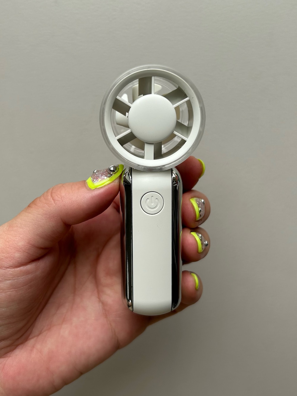 オレンジ系のポーチ、ホワイト系の生活家電、グレー系のヘッドフォン/イヤホンを着用したレディースの夏コーディネートの4枚目の写真