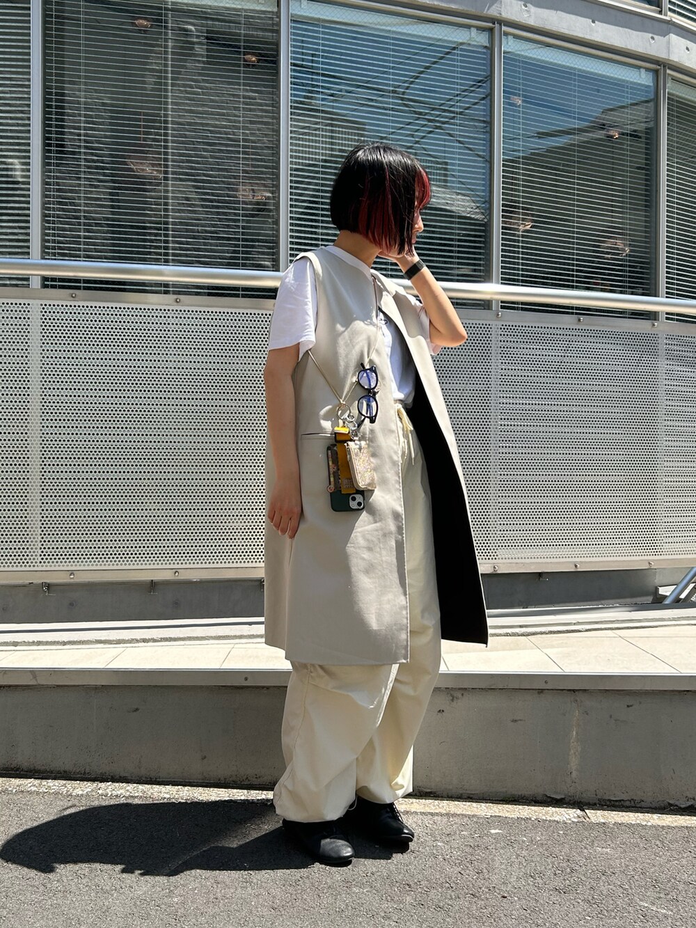 ブラック系のドレスシューズ、ホワイト系のその他パンツ、ブラック系のスマホグッズを着用したレディースの春コーディネートの2枚目の写真