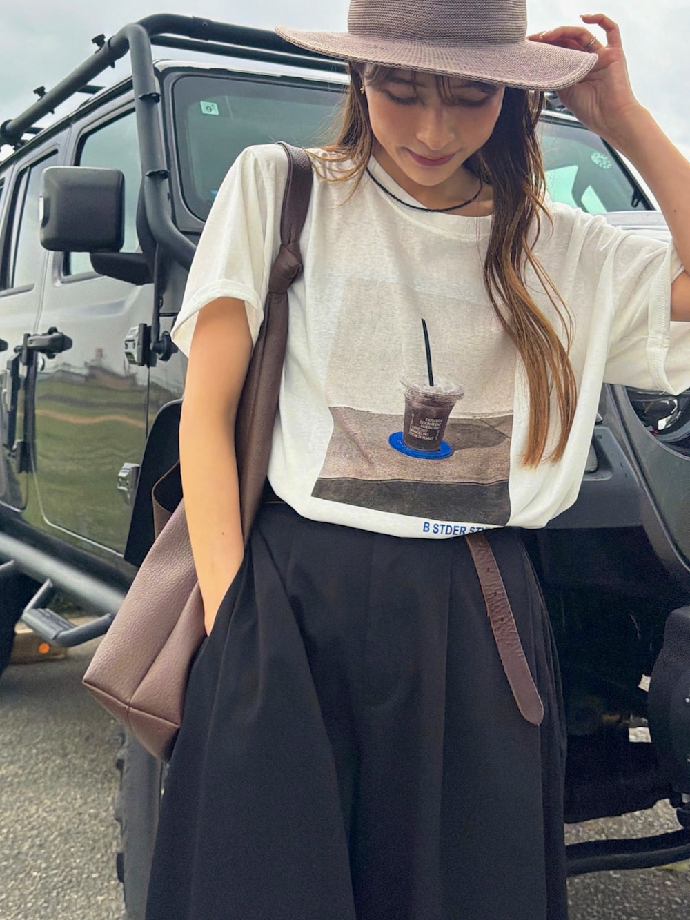 ホワイト系のTシャツ/カットソー、ブラウン系のハット、ホワイト系のストール/ショールを着用したレディースの夏コーディネートの4枚目の写真