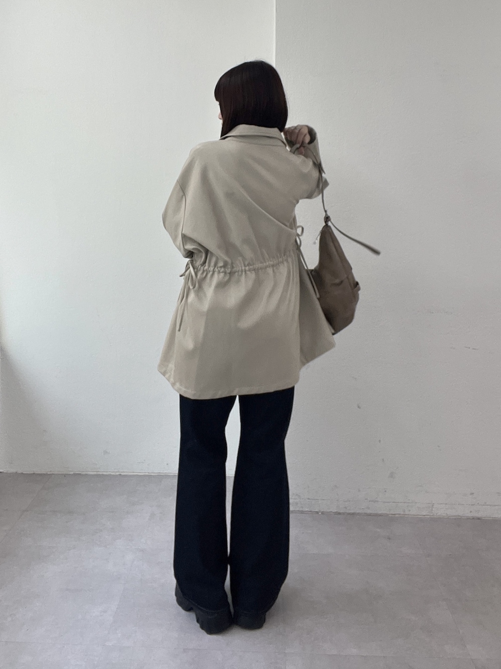 ベージュ系のその他アウター、ホワイト系のTシャツ/カットソー、ブルー系のデニムパンツを着用したレディースの春コーディネートの2枚目の写真