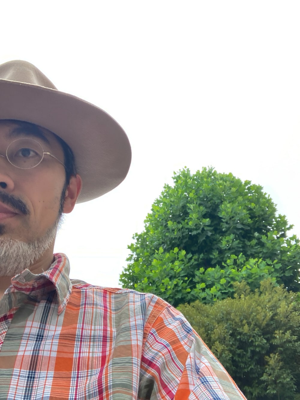 オレンジ系のシャツ/ブラウス、ホワイト系のデニムパンツ、ベージュ系のモカシン/デッキシューズを着用したメンズの夏コーディネートの5枚目の写真