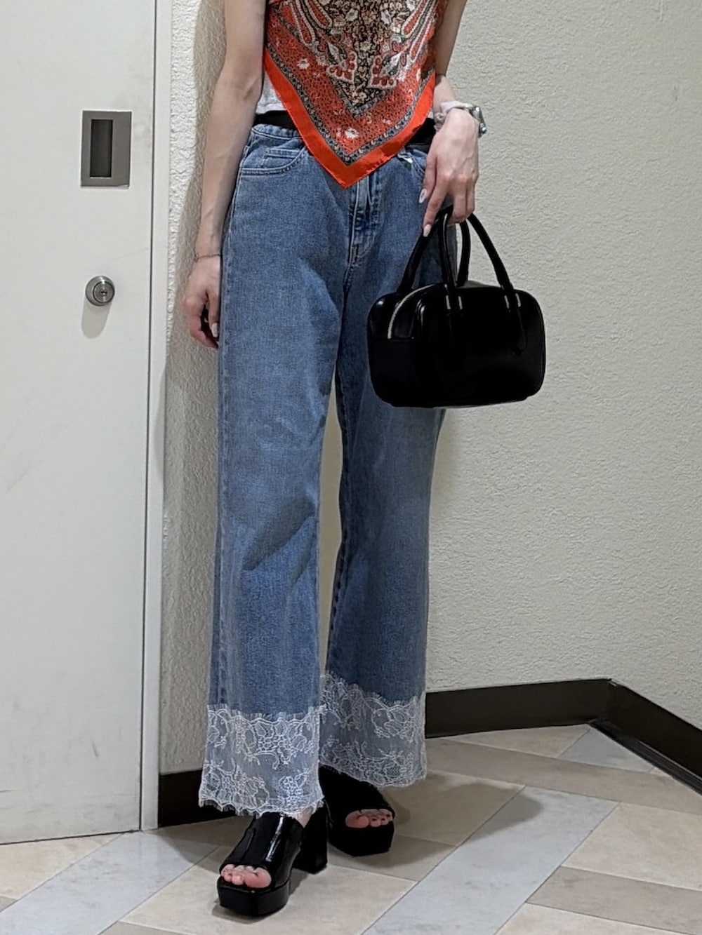 グレー系のTシャツ/カットソー、ブルー系のデニムパンツ、ブラック系のハンドバッグを着用したレディースの夏コーディネートの6枚目の写真