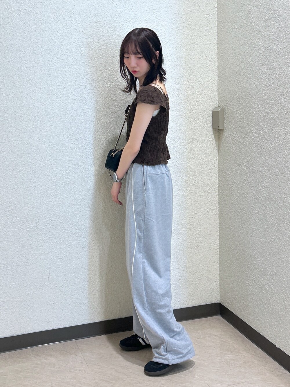 ブラウン系のTシャツ/カットソー、ブラック系のショルダーバッグを着用したレディースの夏コーディネートの2枚目の写真