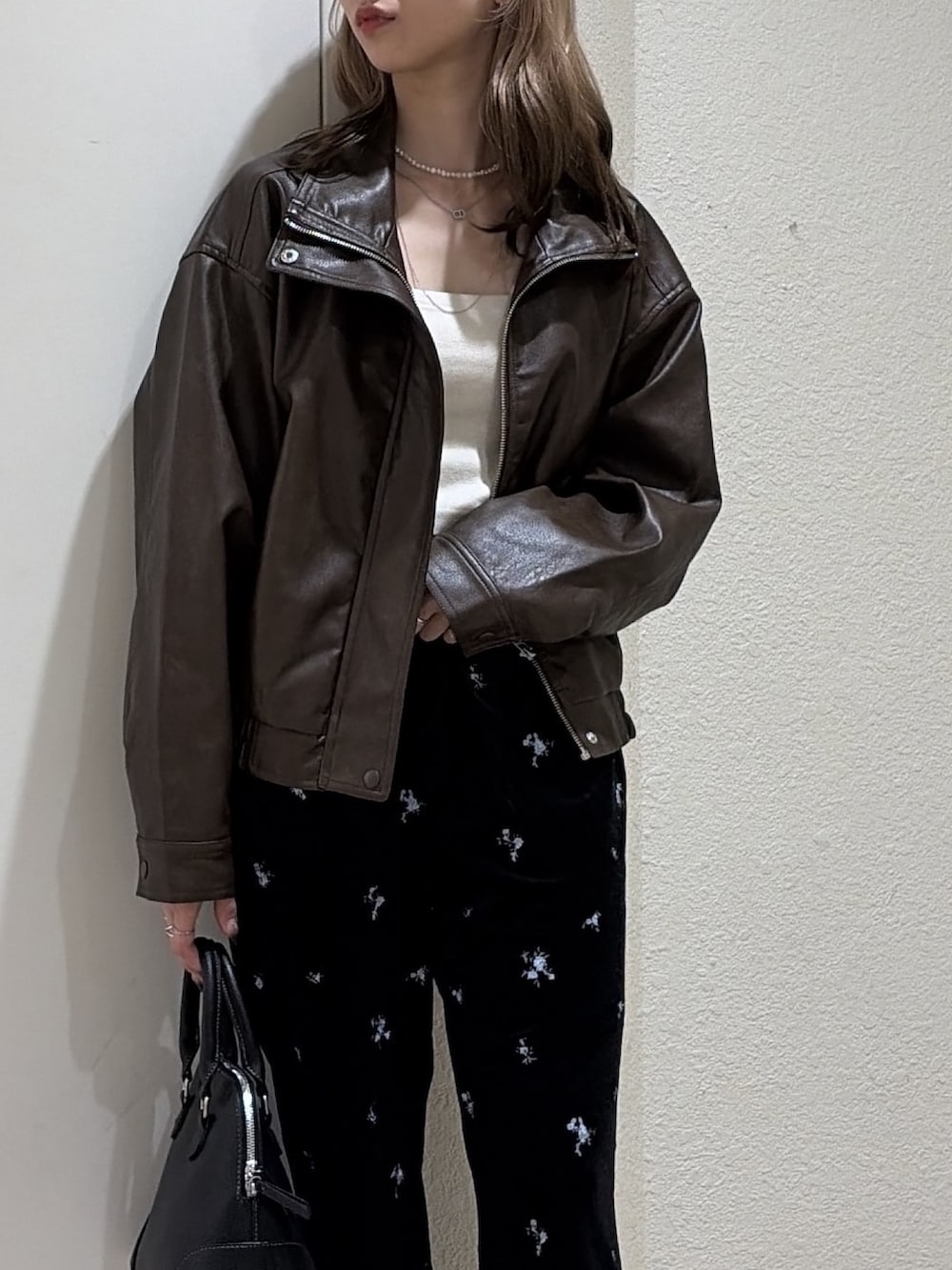 ブラウン系のブルゾン、ブラック系のその他パンツ、ブラック系のショルダーバッグを着用したレディースの秋コーディネートの5枚目の写真