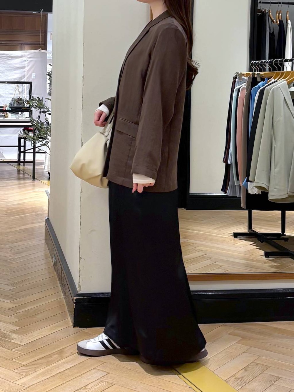 ブラウン系のテーラードジャケット、ベージュ系のショルダーバッグ、ホワイト系のTシャツ/カットソーを着用したレディースの春コーディネートの3枚目の写真