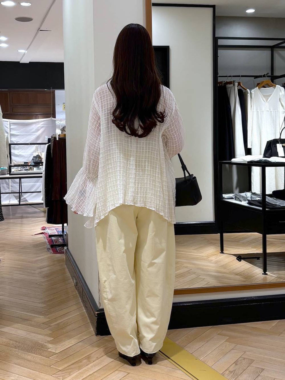 ブラック系のショルダーバッグ、ブラック系のサンダルを着用したレディースの春コーディネートの5枚目の写真