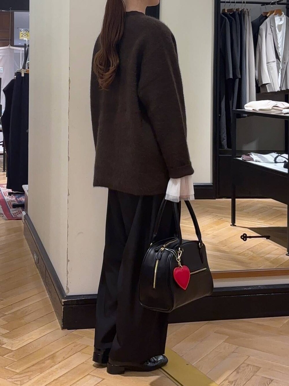 ブラウン系のカーディガン/ボレロ、ブラック系のローファー、ブラック系のスラックスを着用したレディースの秋コーディネートの3枚目の写真