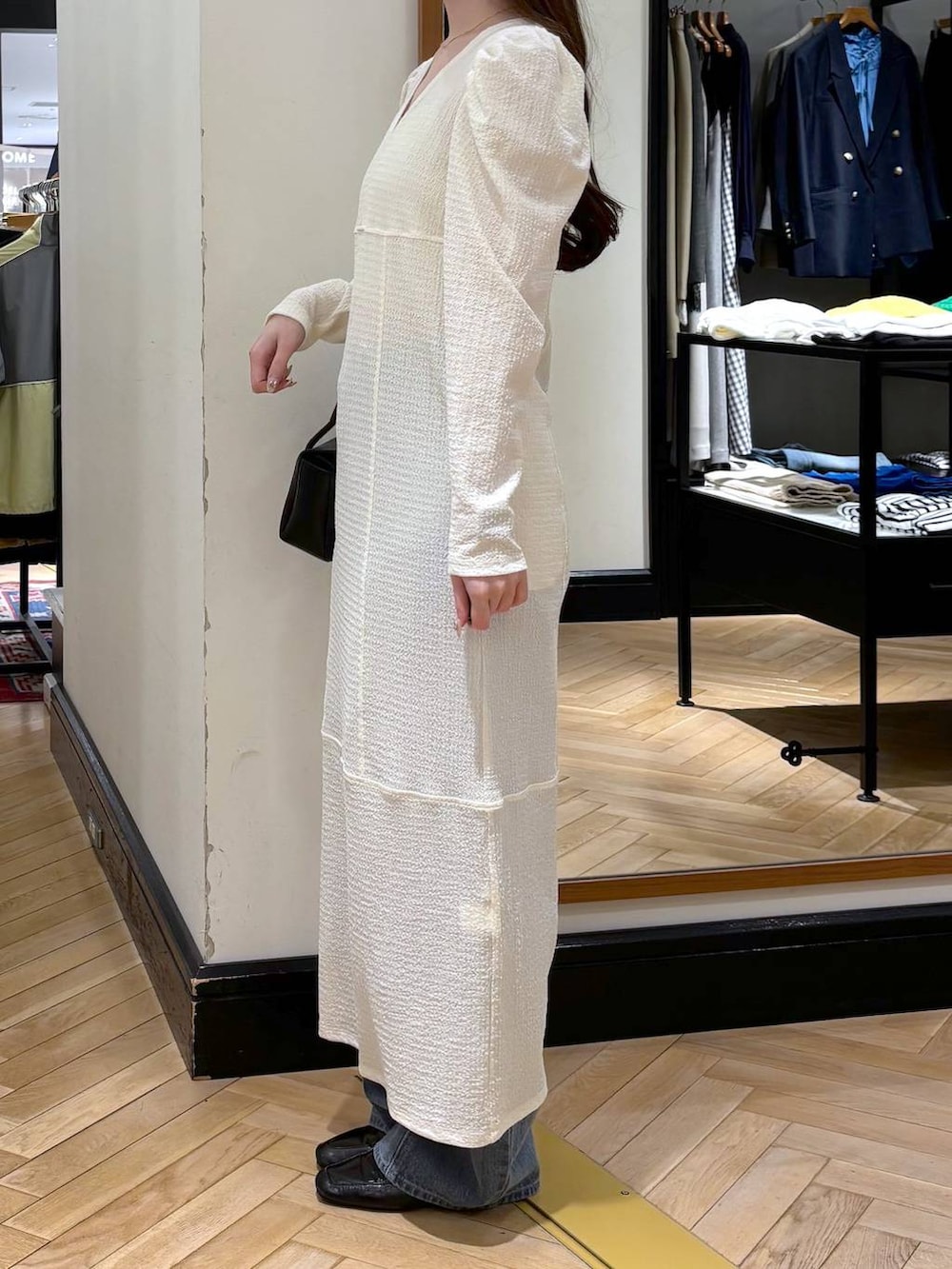 ブルー系のデニムパンツ、ブラック系のローファー、ブラック系のショルダーバッグを着用したレディースの春コーディネートの3枚目の写真