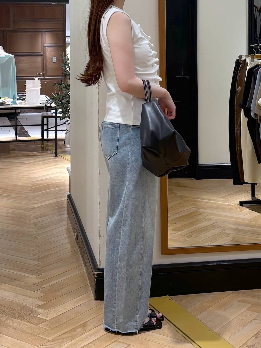 ホワイト系のTシャツ/カットソー、ブラック系のショルダーバッグ、ブルー系のデニムパンツを着用したレディースの夏コーディネートの2枚目の写真