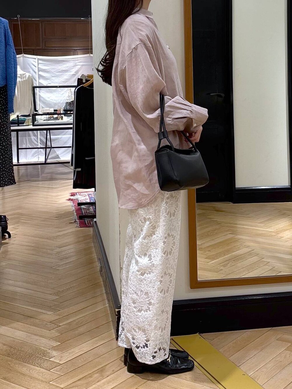 ブラック系のローファー、ピンク系のシャツ/ブラウス、ブラック系のショルダーバッグを着用したレディースの春コーディネートの2枚目の写真