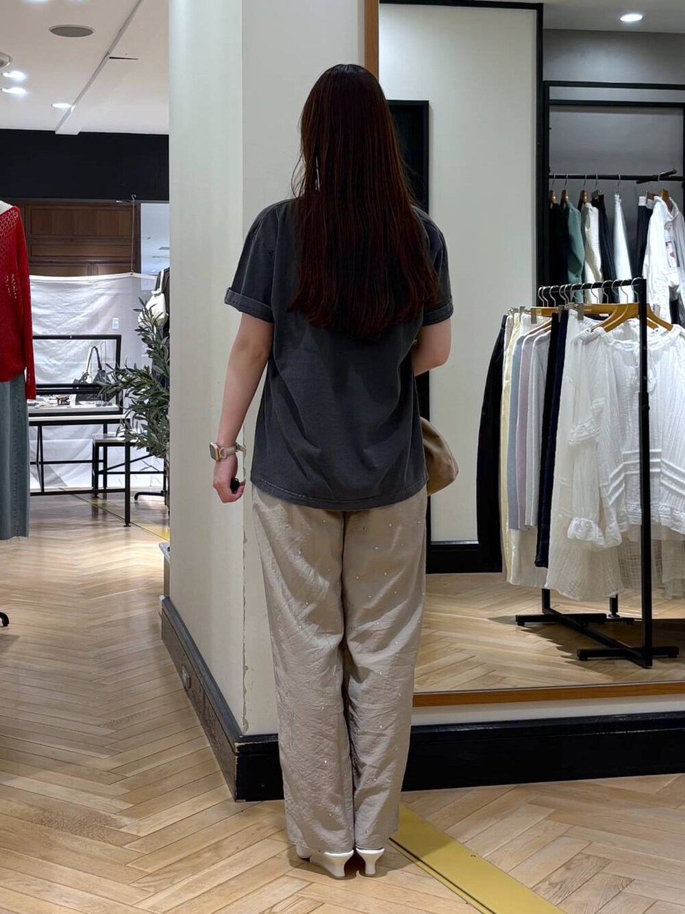 ベージュ系のショルダーバッグ、グレー系のTシャツ/カットソー、ホワイト系のサンダルを着用したレディースの春コーディネートの4枚目の写真