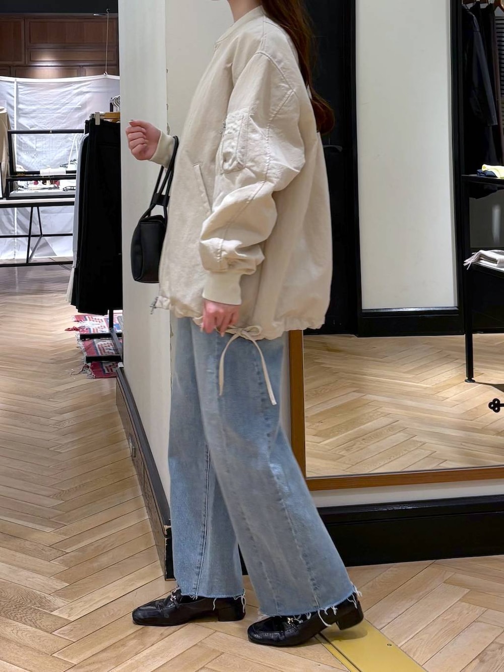 ブラック系のローファー、ベージュ系のMA-1、ブルー系のデニムパンツを着用したレディースの冬コーディネートの4枚目の写真