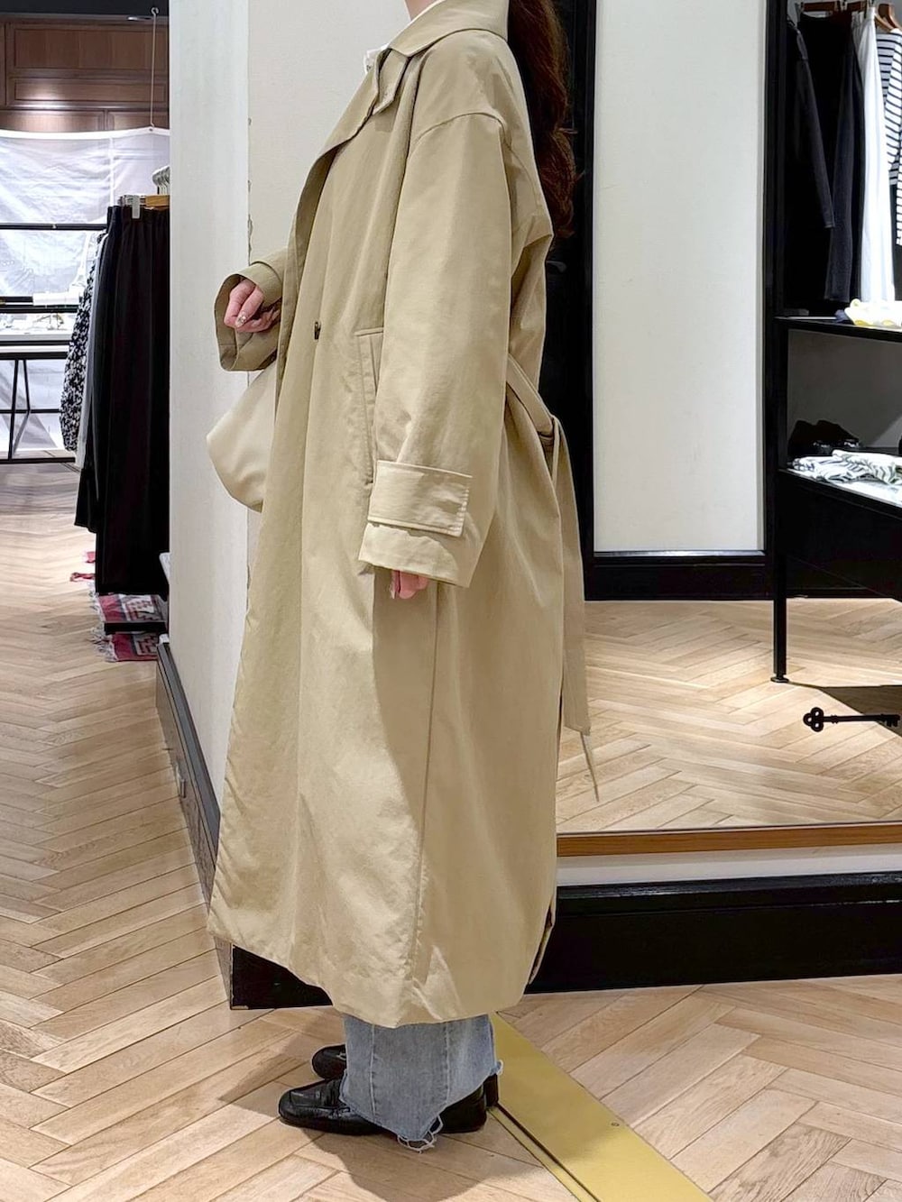 ブラック系のローファー、ブルー系のデニムパンツ、ベージュ系のその他アウターを着用したレディースの冬コーディネートの4枚目の写真