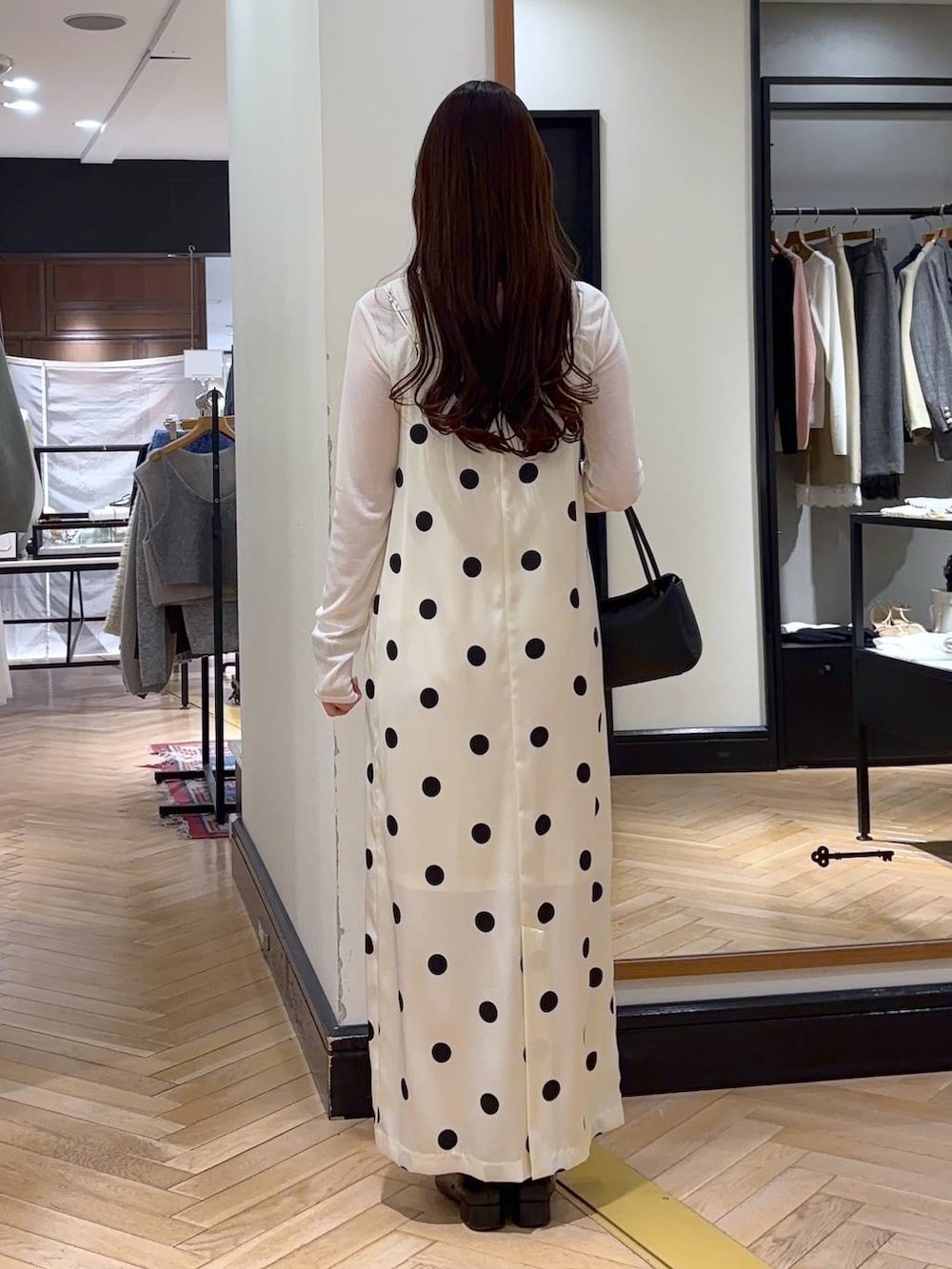 ブラック系のローファー、ホワイト系のTシャツ/カットソー、ブラック系のショルダーバッグを着用したレディースの冬コーディネートの4枚目の写真