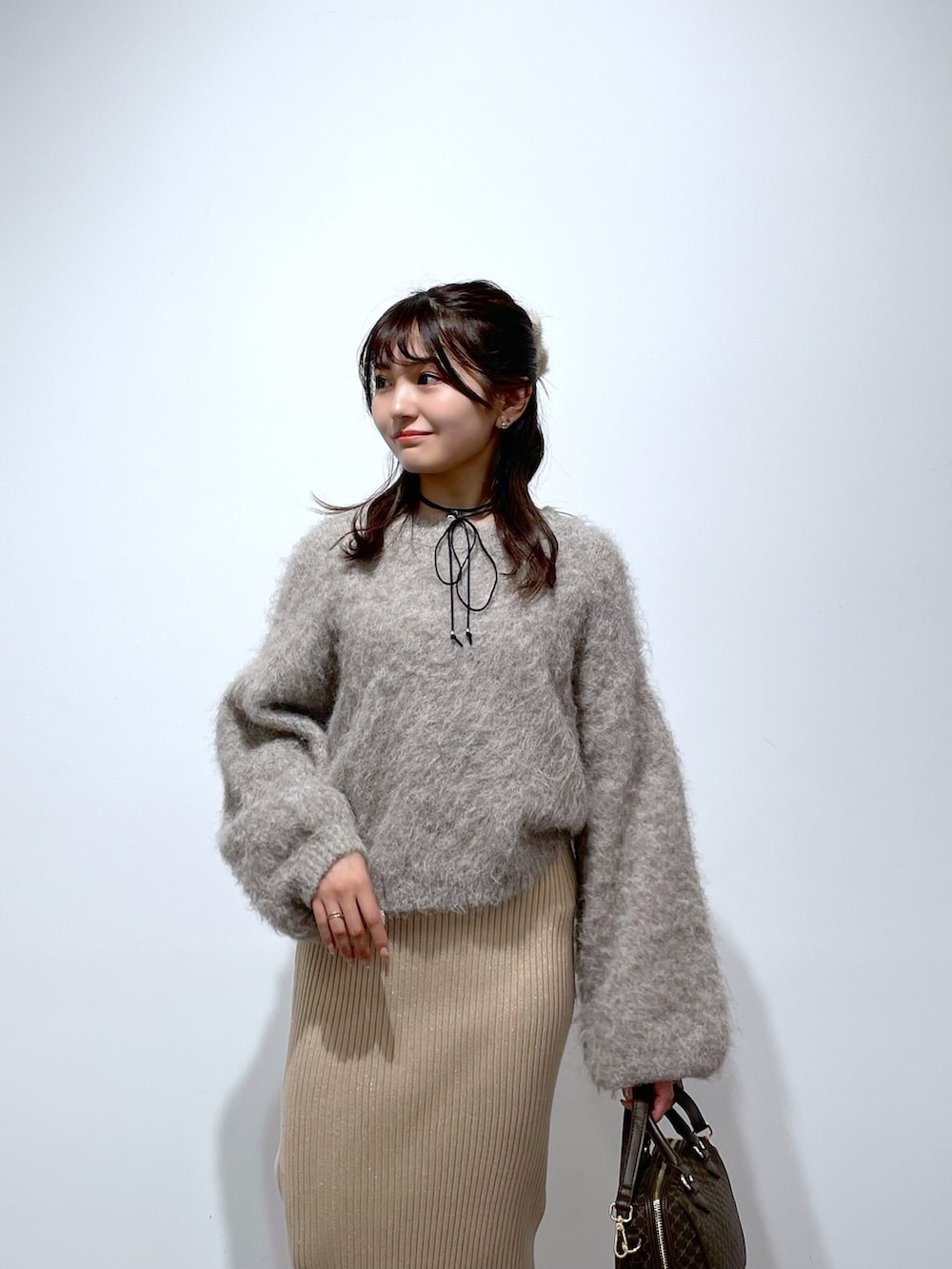 ベージュ系のニット/セーター、ゴールド系のスカート、ブラウン系のバレエシューズを着用したレディースの冬コーディネートの4枚目の写真