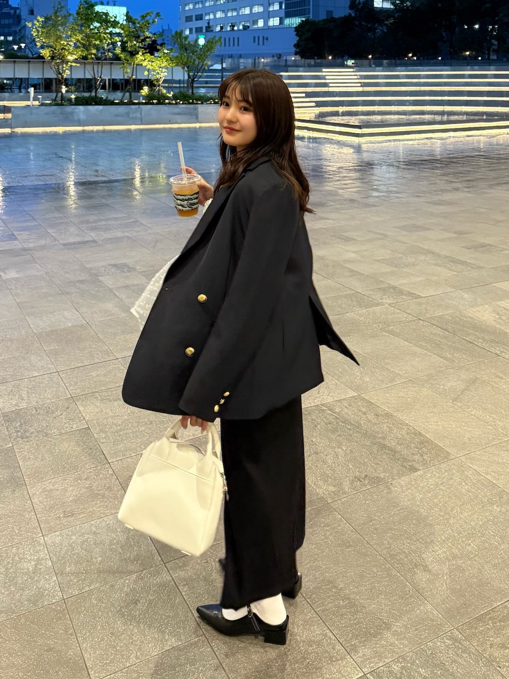 ブルー系のテーラードジャケット、ベージュ系のシャツ/ブラウス、ブラック系のワンピースを着用したレディースの春コーディネートの2枚目の写真