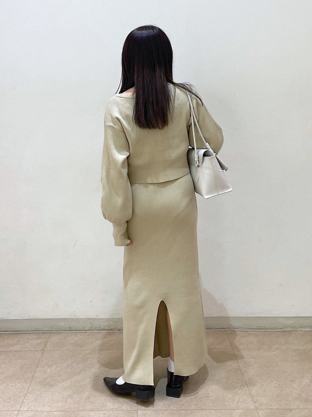 ベージュ系のワンピース、ベージュ系のカーディガン/ボレロ、ブラック系のバレエシューズを着用したレディースの春コーディネートの3枚目の写真