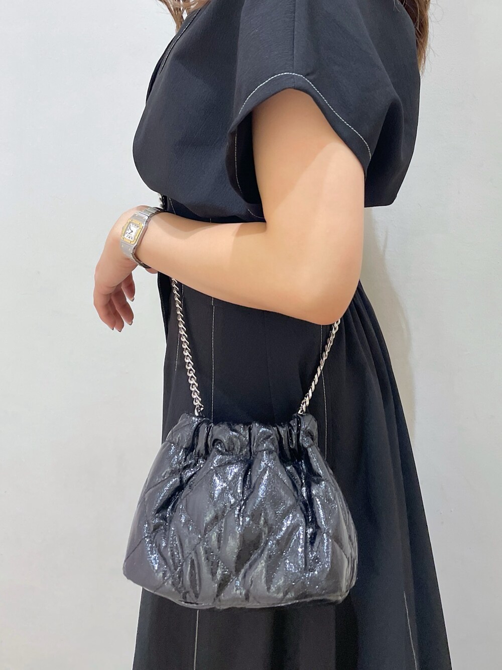 ブラック系のワンピース、ブラック系のショルダーバッグ、ブラック系のサンダルを着用したレディースの夏コーディネートの8枚目の写真