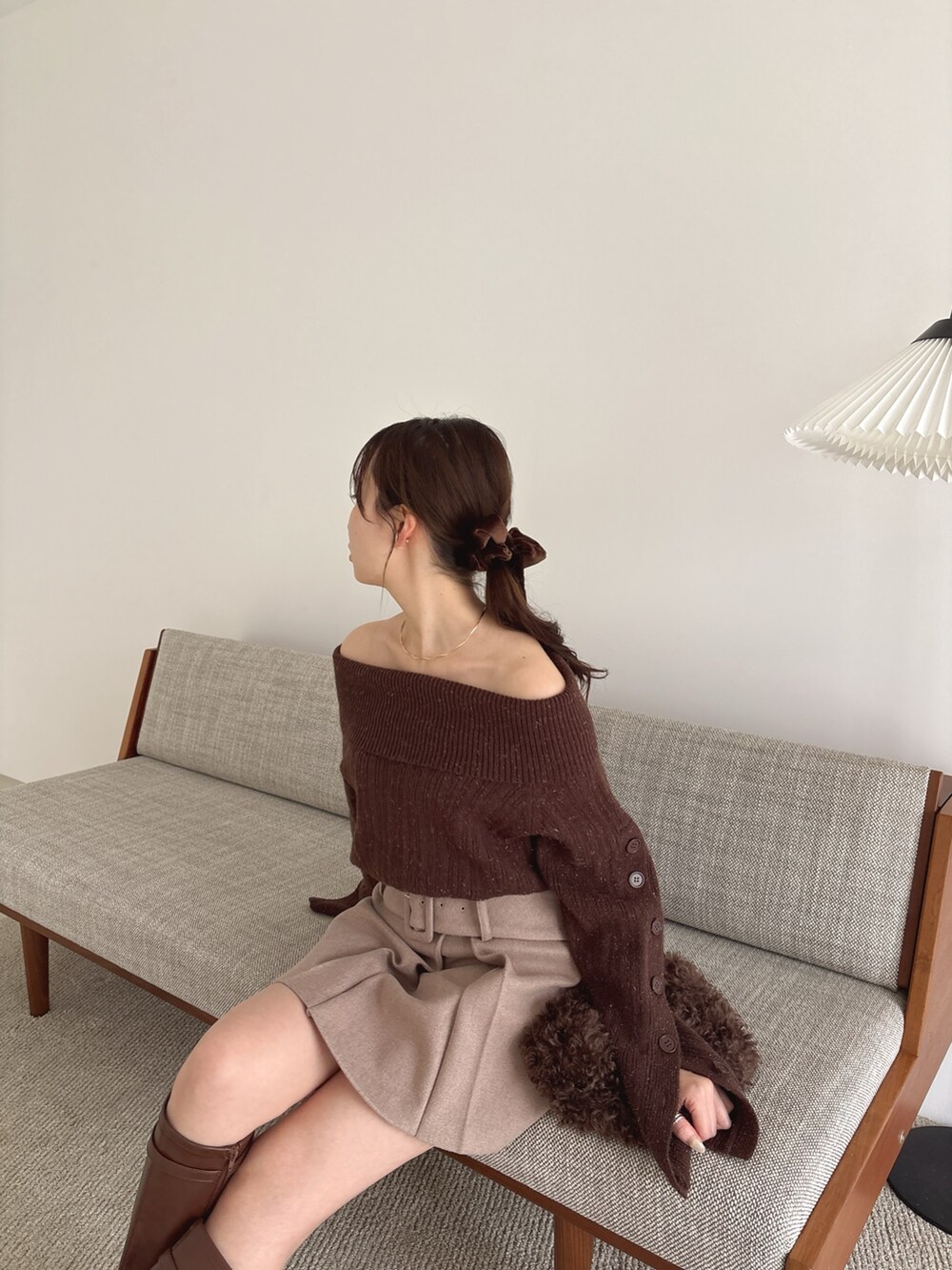 ブラウン系のニット/セーター、ブラウン系のスカート、ブラウン系のブーツを着用したレディースの秋コーディネートの7枚目の写真