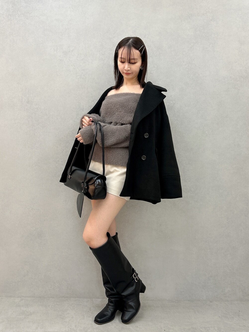 ブラック系のその他アウター、ブラウン系のニット/セーター、ホワイト系のその他パンツを着用したレディースの冬コーディネートの2枚目の写真