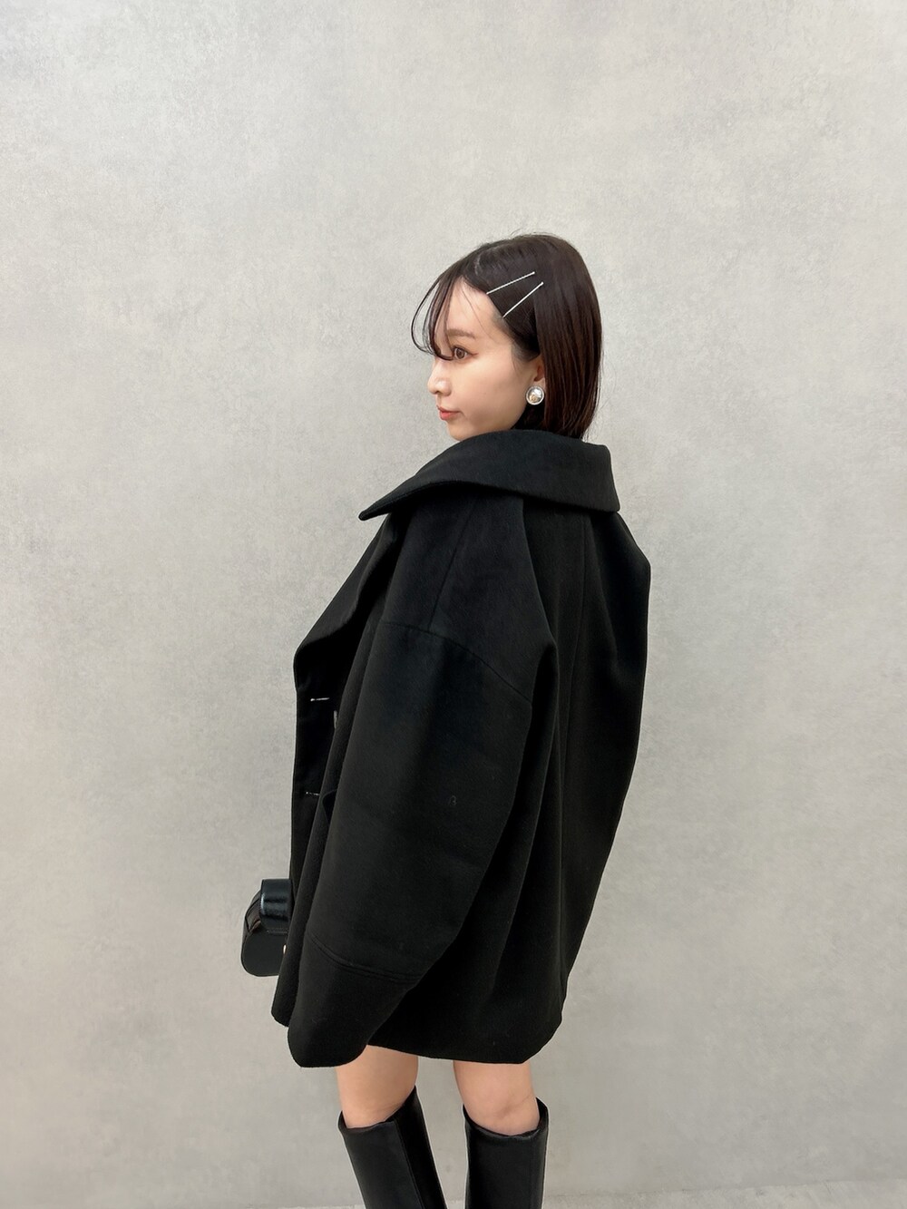 ブラック系のその他アウター、ブラウン系のニット/セーター、ホワイト系のその他パンツを着用したレディースの冬コーディネートの5枚目の写真