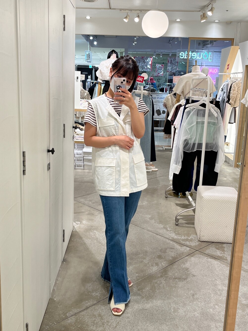 ホワイト系のダウンベスト、ホワイト系のTシャツ/カットソー、ブラウン系のTシャツ/カットソーを着用したレディースの夏コーディネートの2枚目の写真