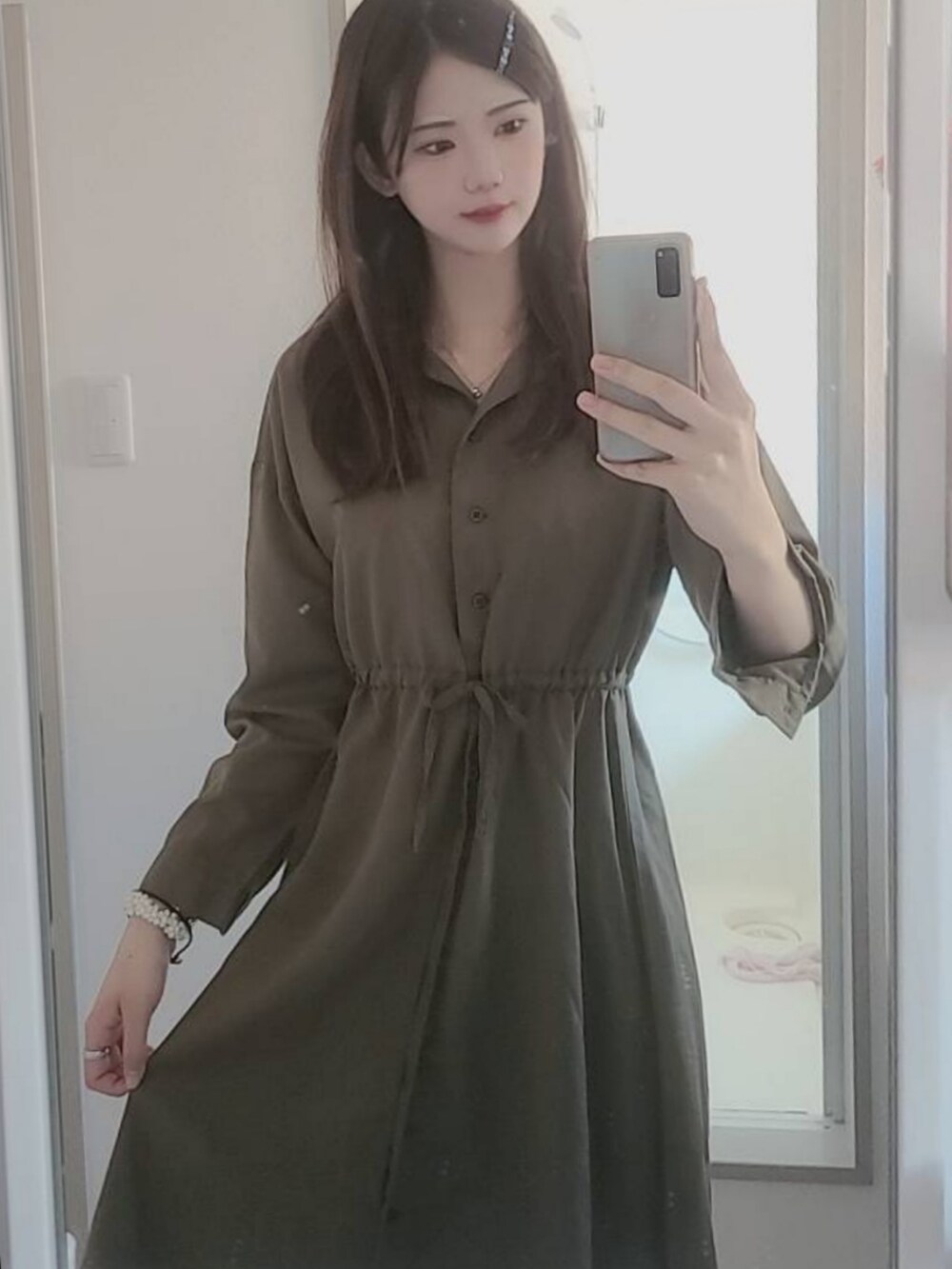 グリーン系のシャツワンピースを着用したレディースの夏コーディネートの2枚目の写真