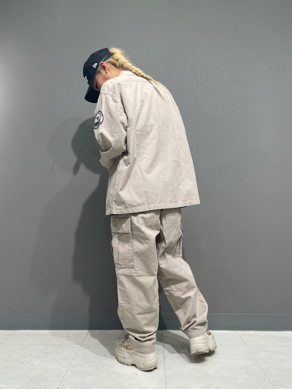 グレー系のカーゴパンツ、ブルー系のTシャツ/カットソー、ベージュ系のシャツ/ブラウスを着用したレディースの春コーディネートの2枚目の写真