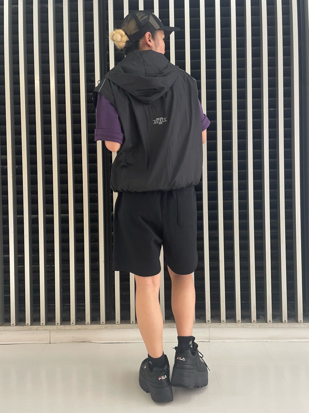 ブラック系のその他パンツ、ブラック系のナイロンジャケット、パープル系のTシャツ/カットソーを着用したレディースの夏コーディネートの2枚目の写真