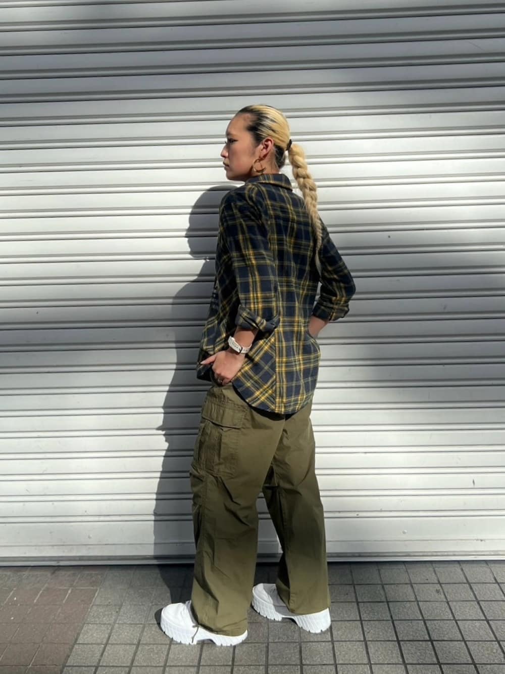 グリーン系のカーゴパンツ、イエロー系のシャツ/ブラウス、ブラック系のタンクトップを着用したレディースの夏コーディネートの2枚目の写真