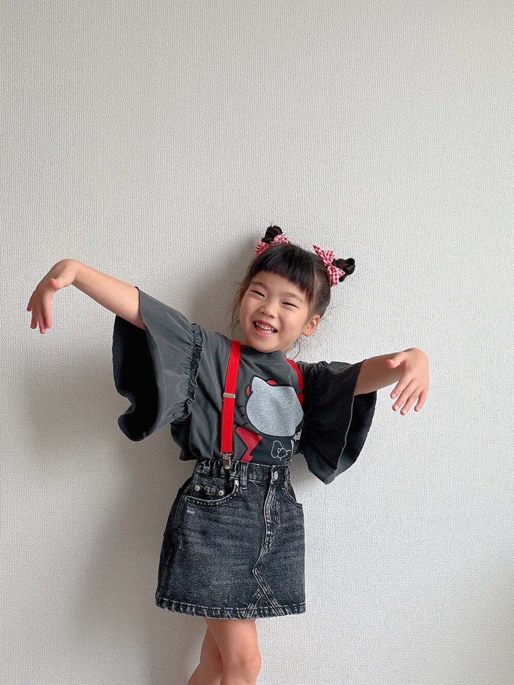 ブラック系のデニムスカート、ブラック系のスニーカー、グレー系のTシャツ/カットソーを着用したキッズの夏コーディネートの3枚目の写真