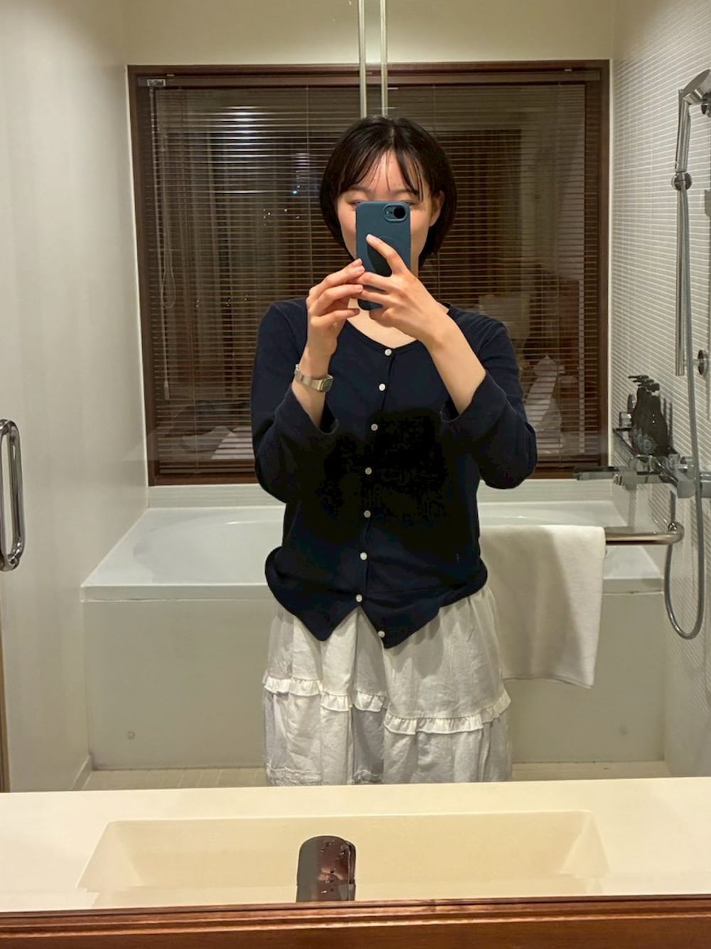 ブルー系のスニーカー、レッド系のハンドバッグを着用したレディースの春コーディネートの3枚目の写真