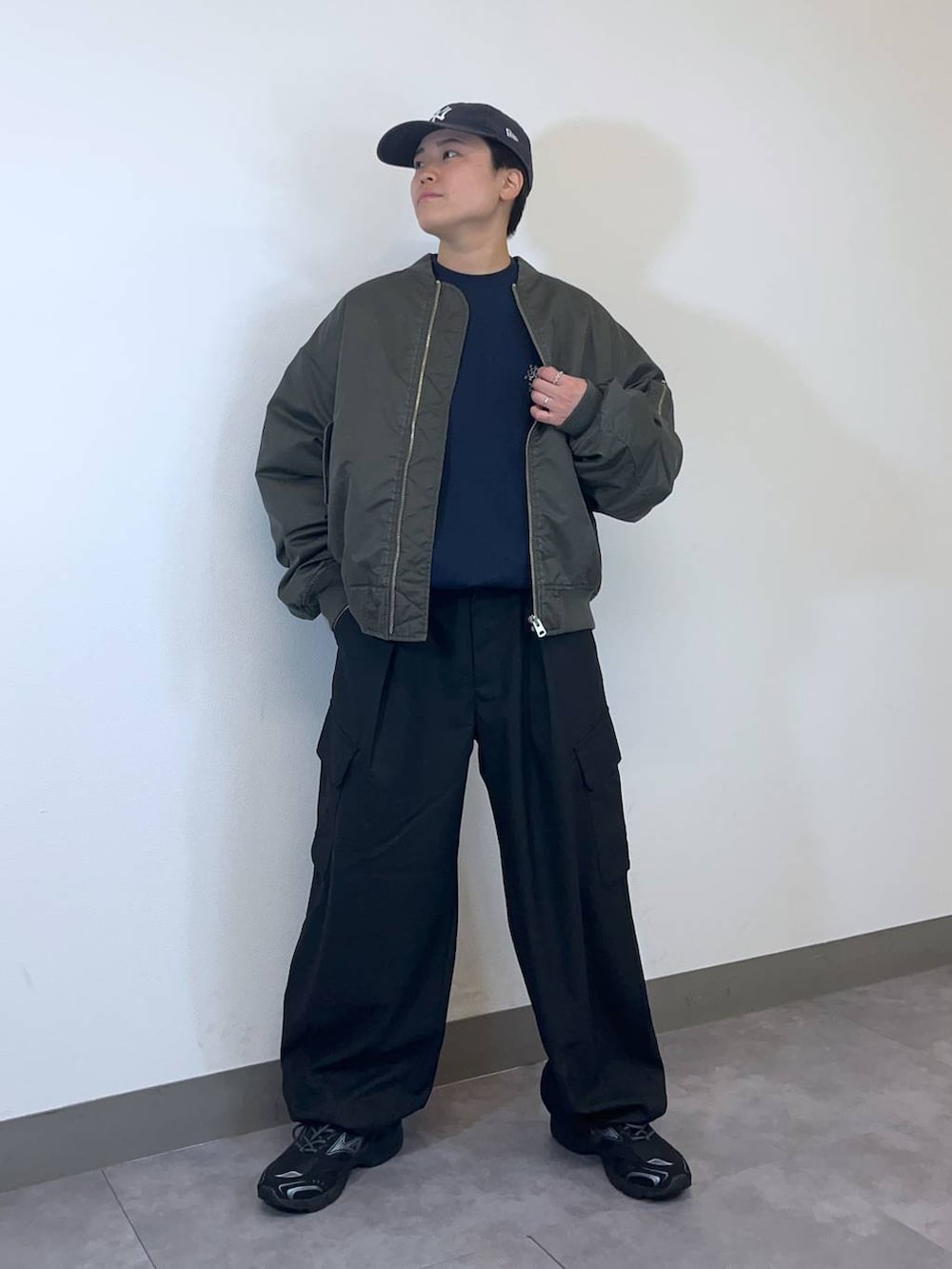 ブラック系のスニーカー、グリーン系のMA-1、ブラック系のスラックスを着用したメンズの冬コーディネートの7枚目の写真