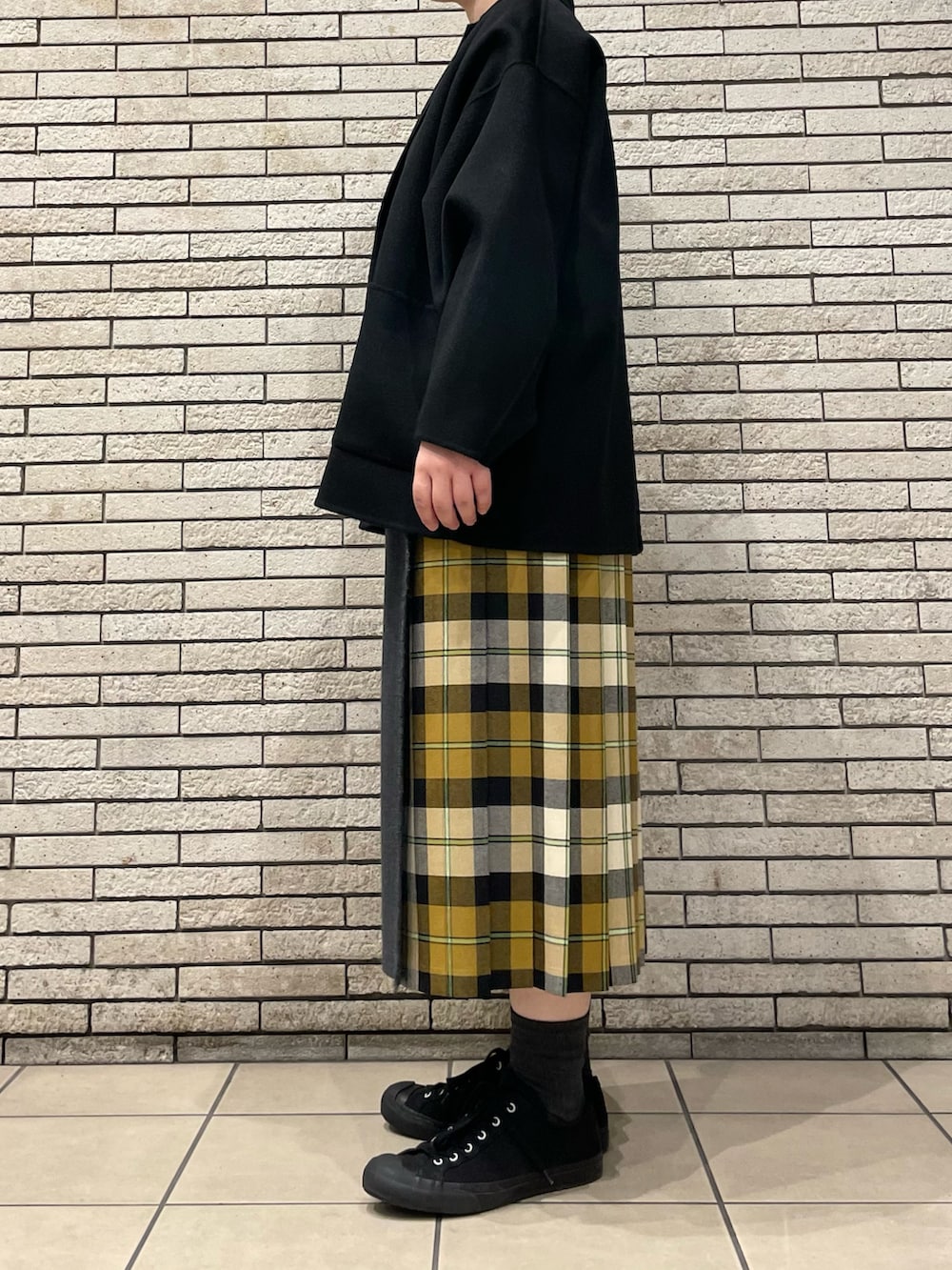 ブラック系のその他アウター、ベージュ系のスカートを着用したレディースの秋コーディネートの5枚目の写真