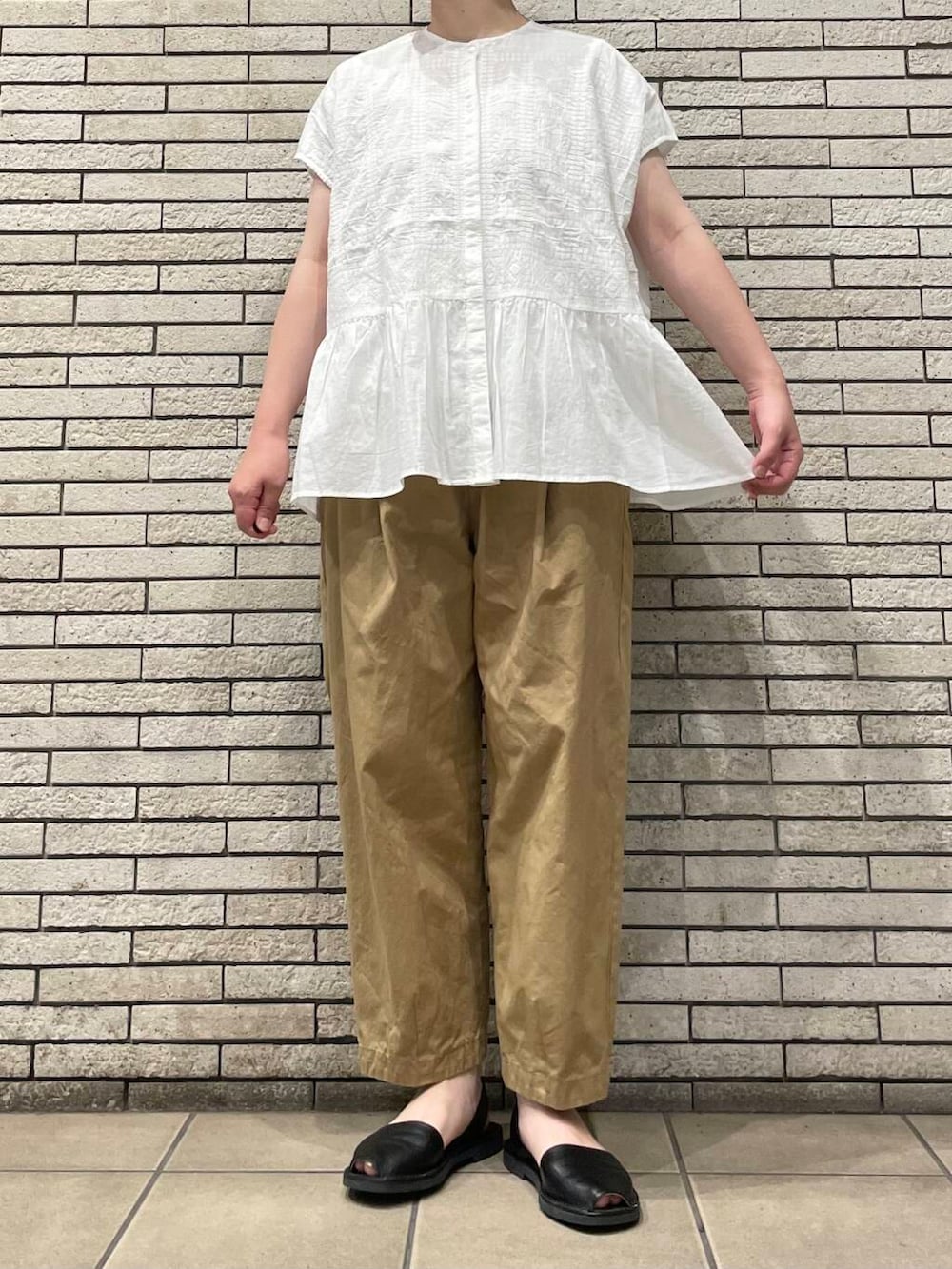 ベージュ系のその他パンツ、ホワイト系のシャツ/ブラウスを着用したレディースの夏コーディネートの3枚目の写真
