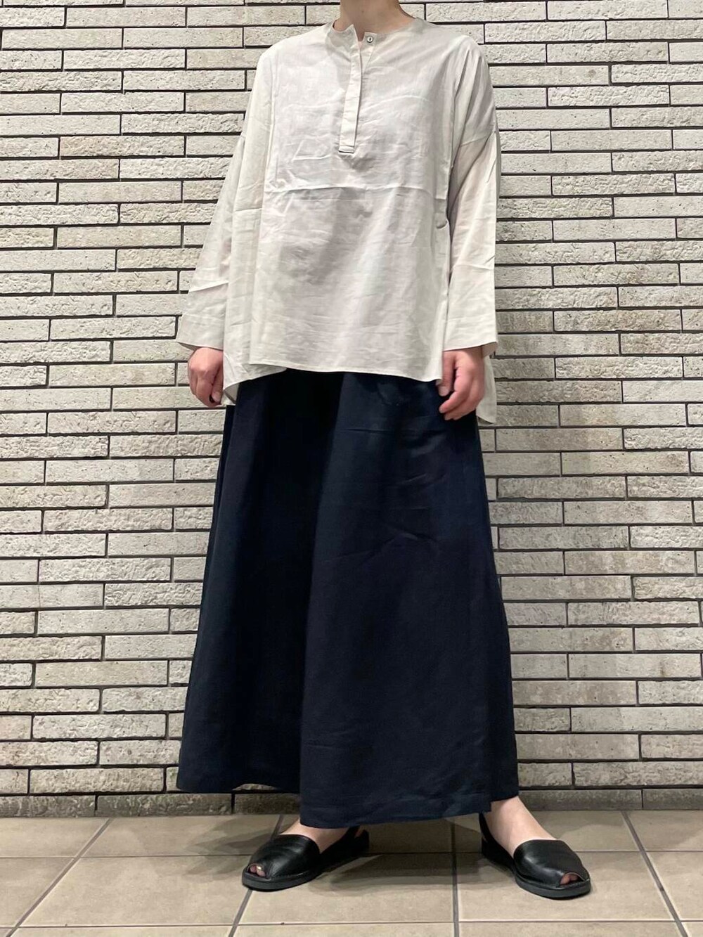 ブラック系のその他パンツ、ベージュ系のシャツ/ブラウスを着用したレディースの夏コーディネートの3枚目の写真