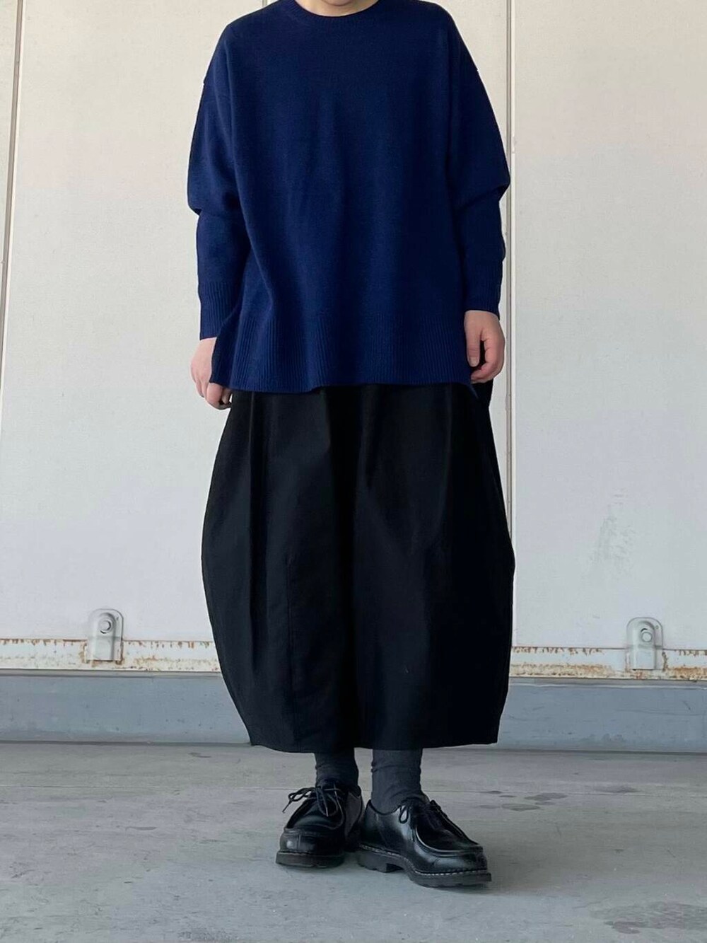 ブラック系のスカート、ブルー系のニット/セーターを着用したレディースの冬コーディネートの2枚目の写真