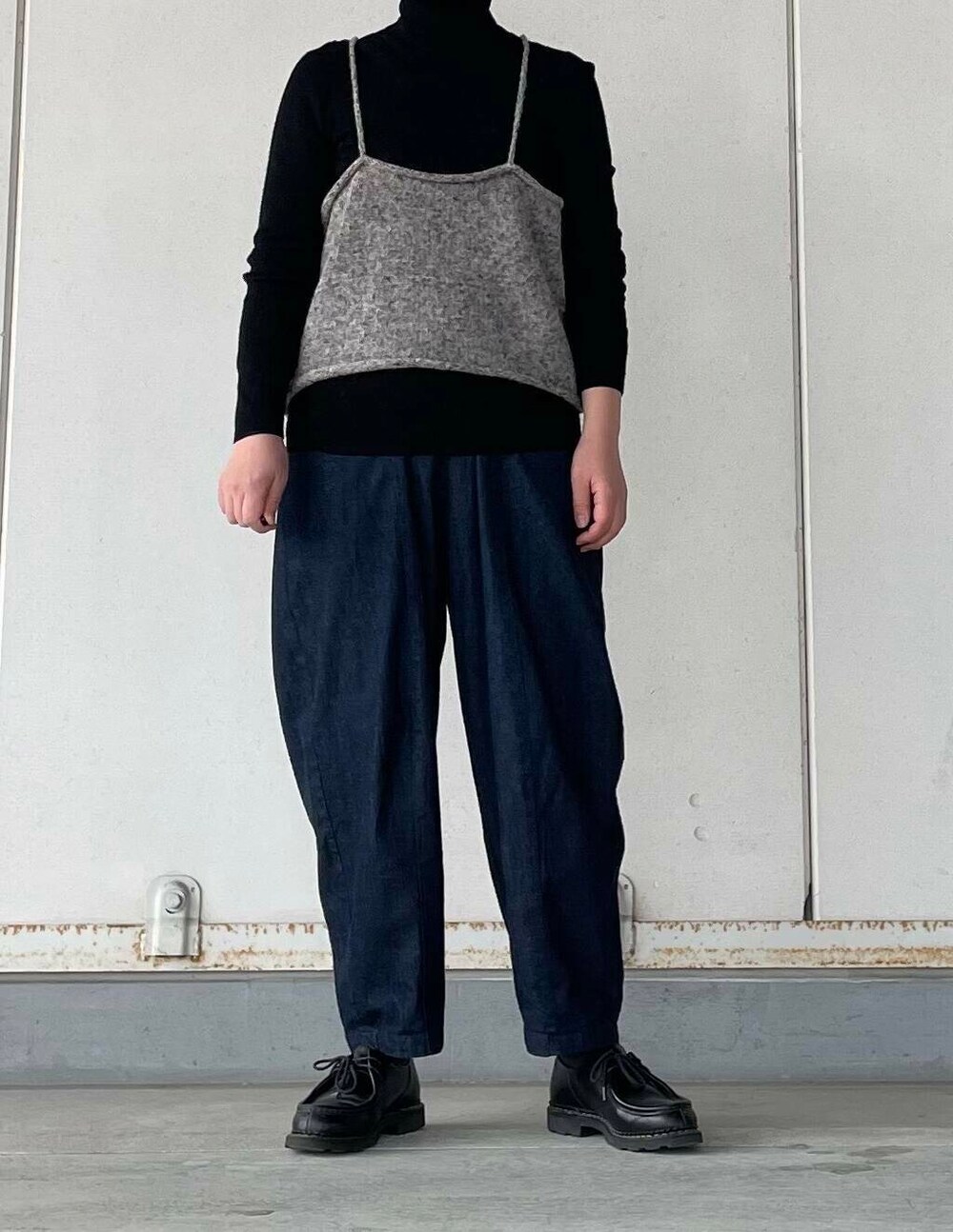 グレー系のキャミソール、ブルー系のデニムパンツを着用したレディースの冬コーディネートの2枚目の写真