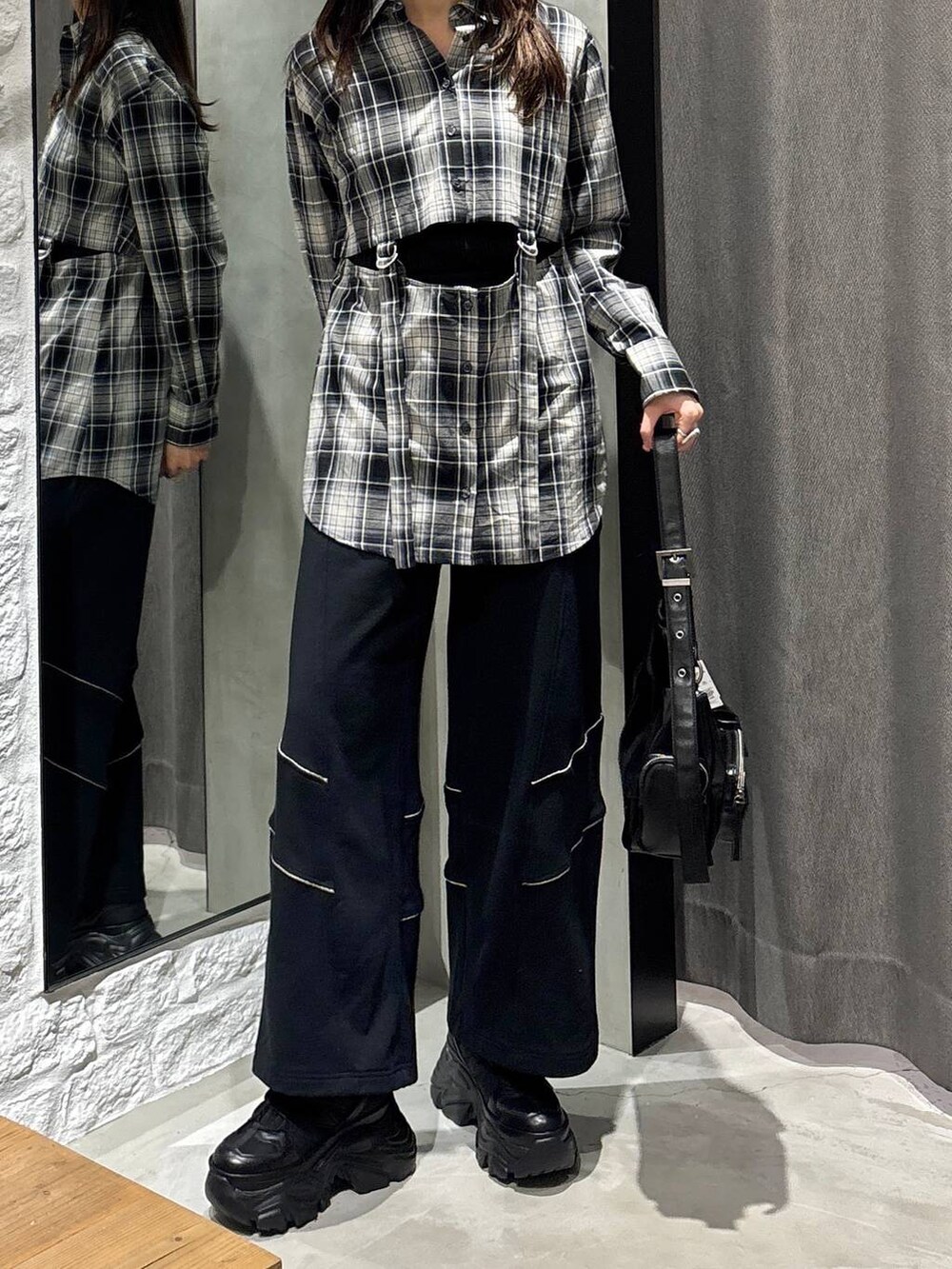 ブラック系のスニーカー、ブラック系のショルダーバッグ、ブラック系のその他パンツを着用したレディースの冬コーディネートの2枚目の写真