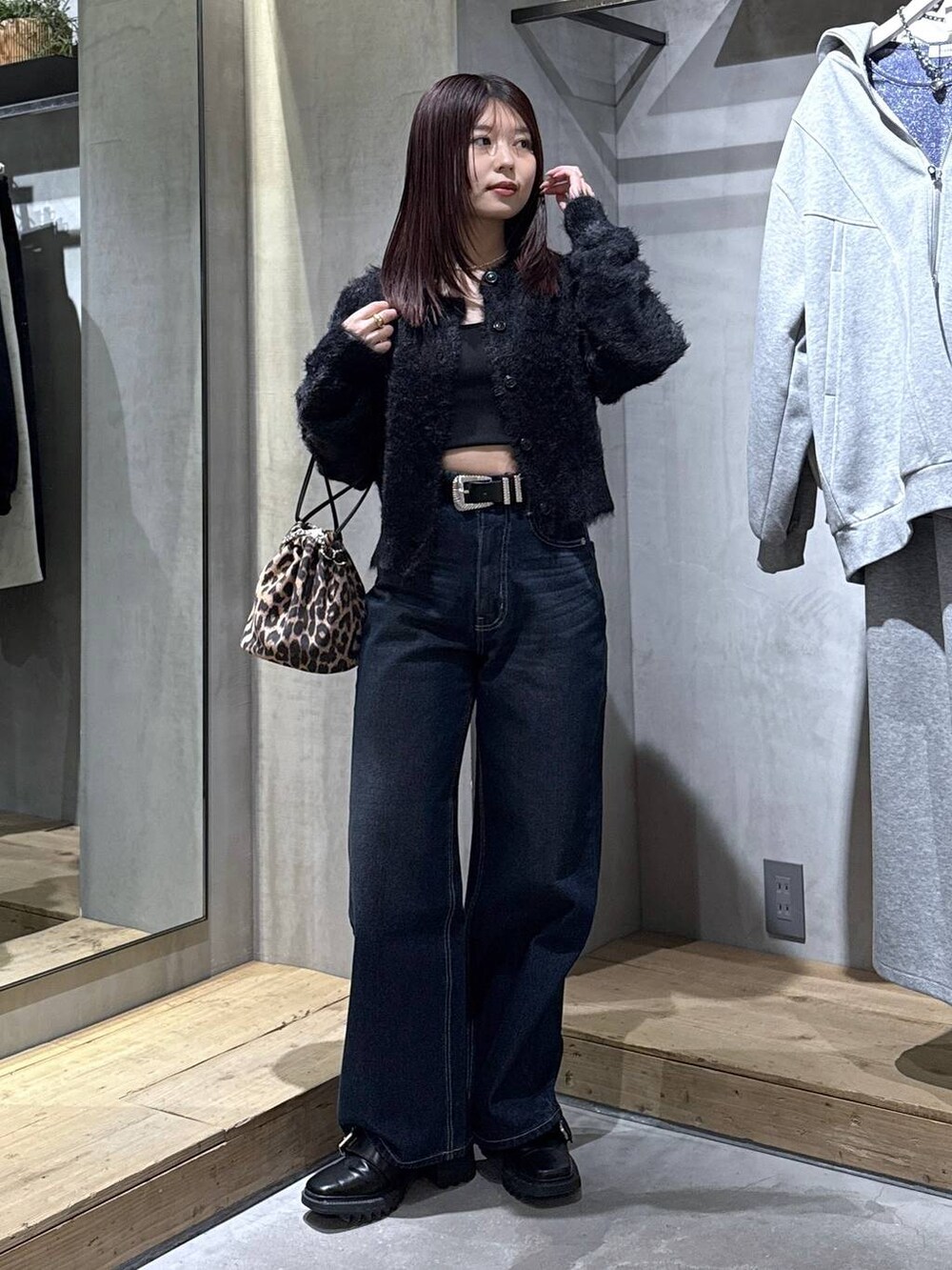 ブラック系のキャミソール、ブラック系のブーツ、その他のハンドバッグを着用したレディースの冬コーディネートの6枚目の写真