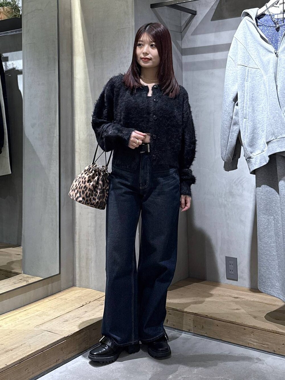 ブラック系のキャミソール、ブラック系のブーツ、その他のハンドバッグを着用したレディースの冬コーディネートの3枚目の写真