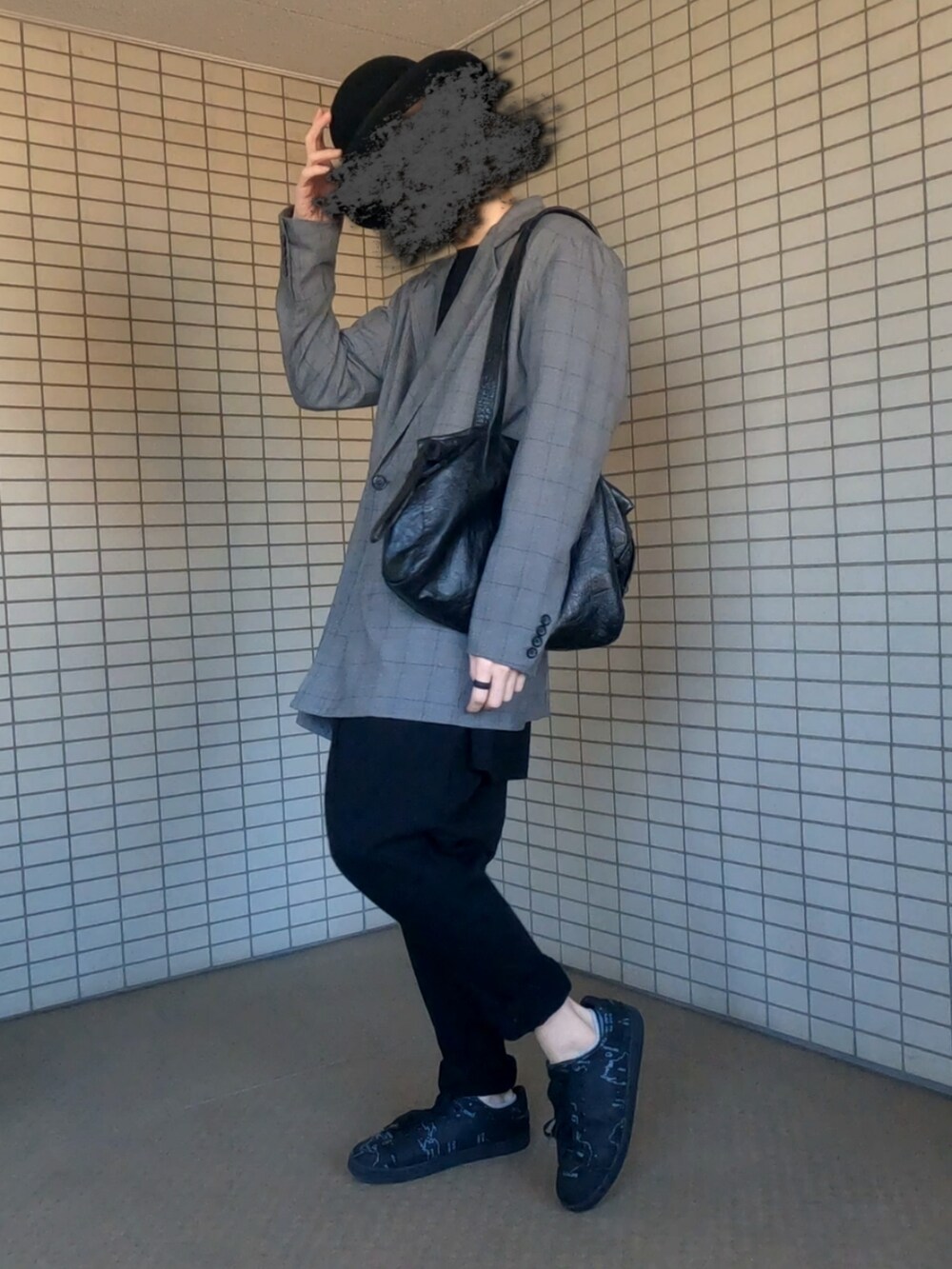 グレー系のテーラードジャケット、ブラック系のボストンバッグ、ブラック系のスニーカーを着用したメンズの春コーディネートの2枚目の写真